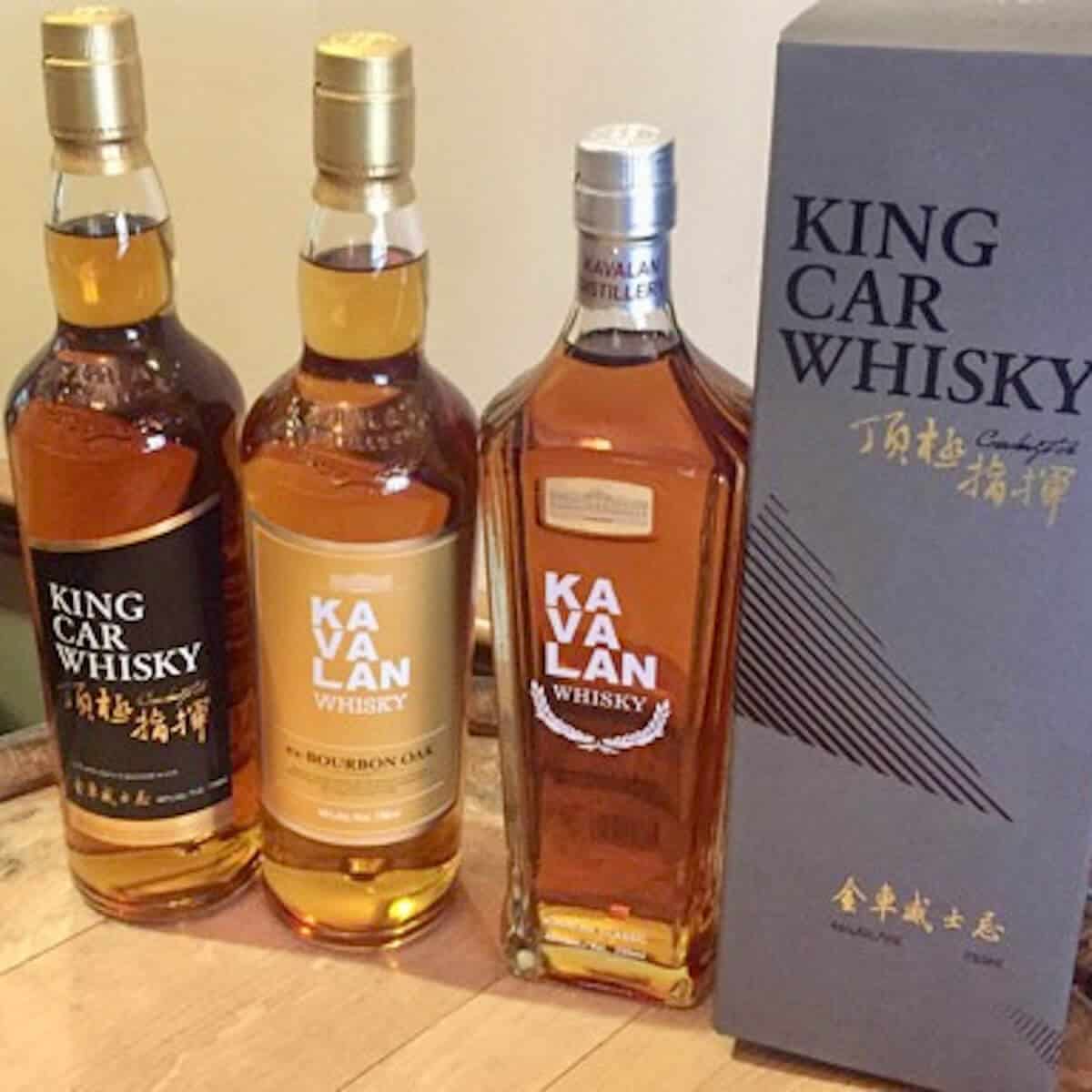 Partial Kavalan lineup in bottles on a barrelhead.