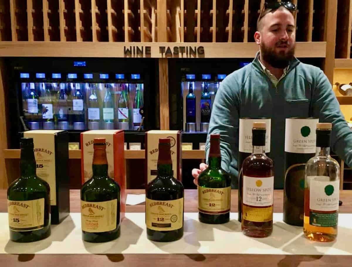 Redbreast, Yellow Spot, & Green Spot bottles on a counter in front of rep.