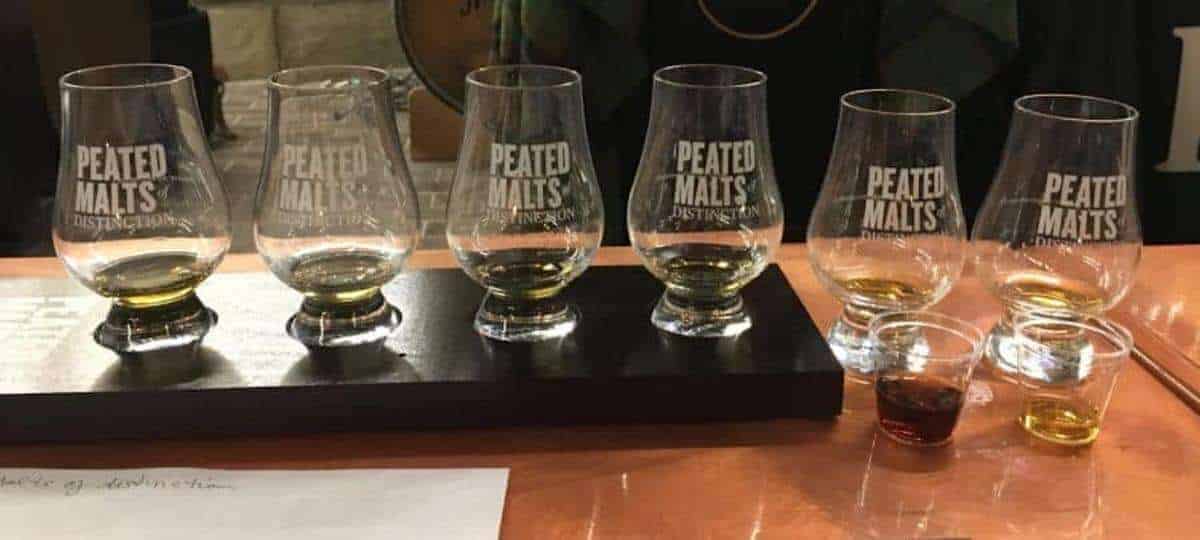 Glen Cairn glasses with the scotch samples on a table.