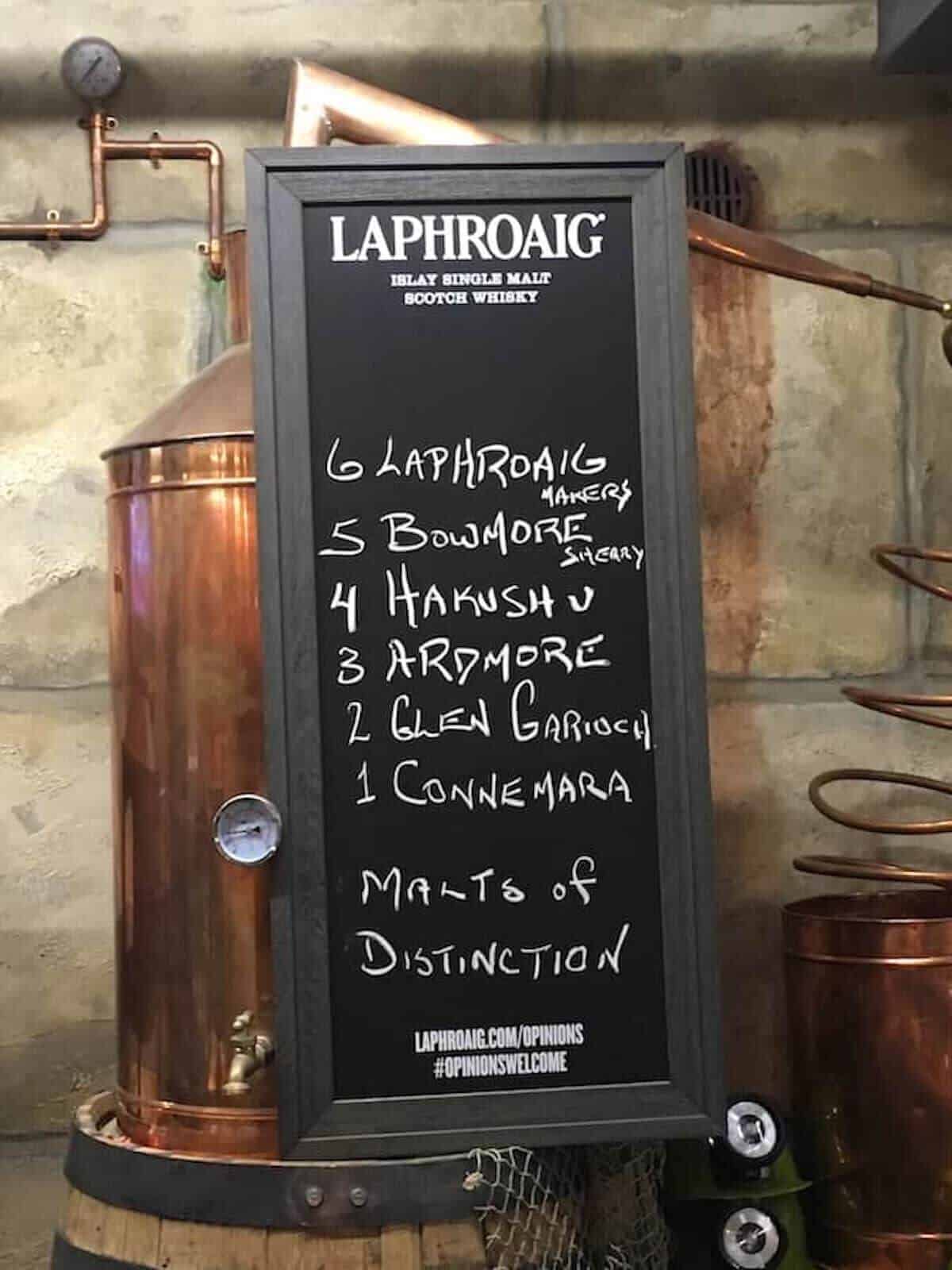 Chalkboard sign listing the peated scotch lineup.