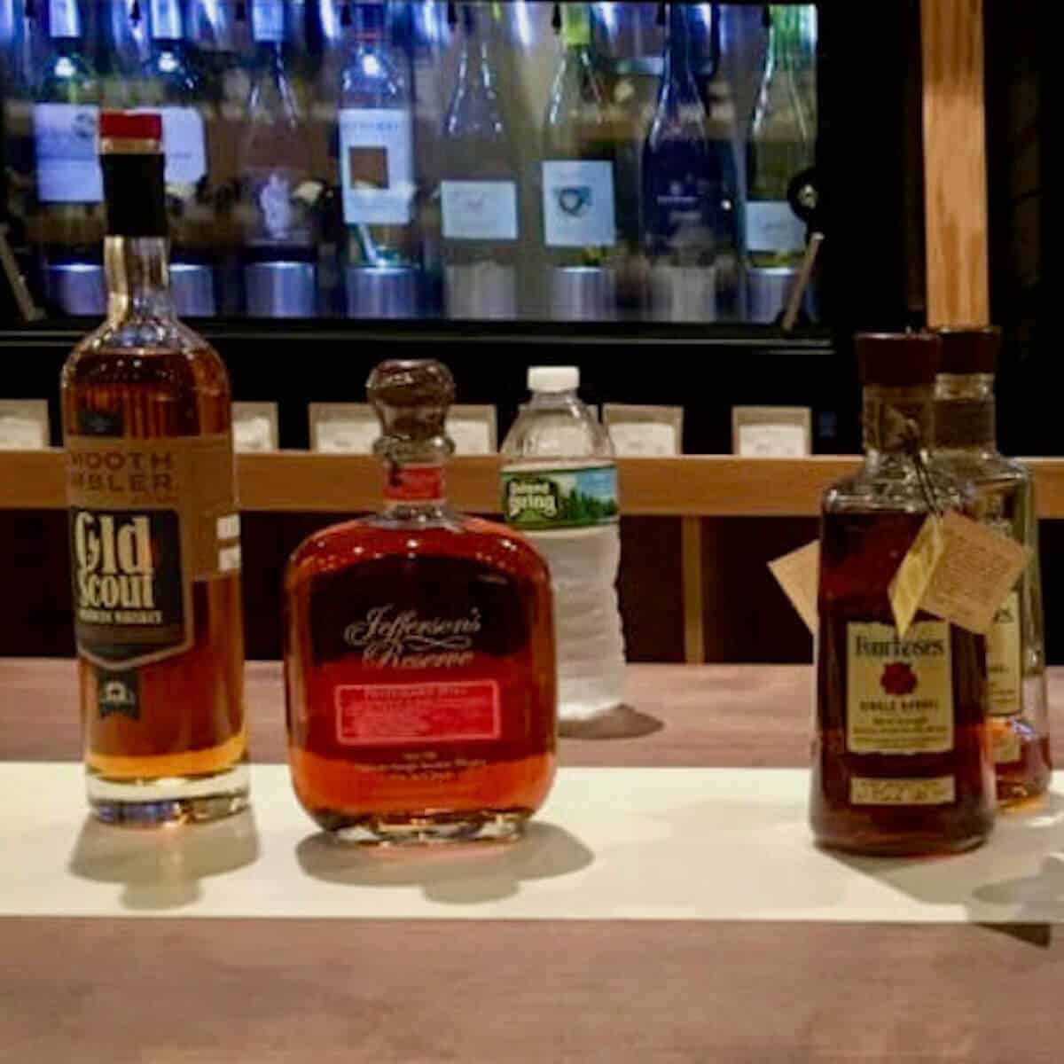 American whiskey lineup in bottles on a counter.