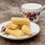 Scottish shortbread on white china plate with teacup.