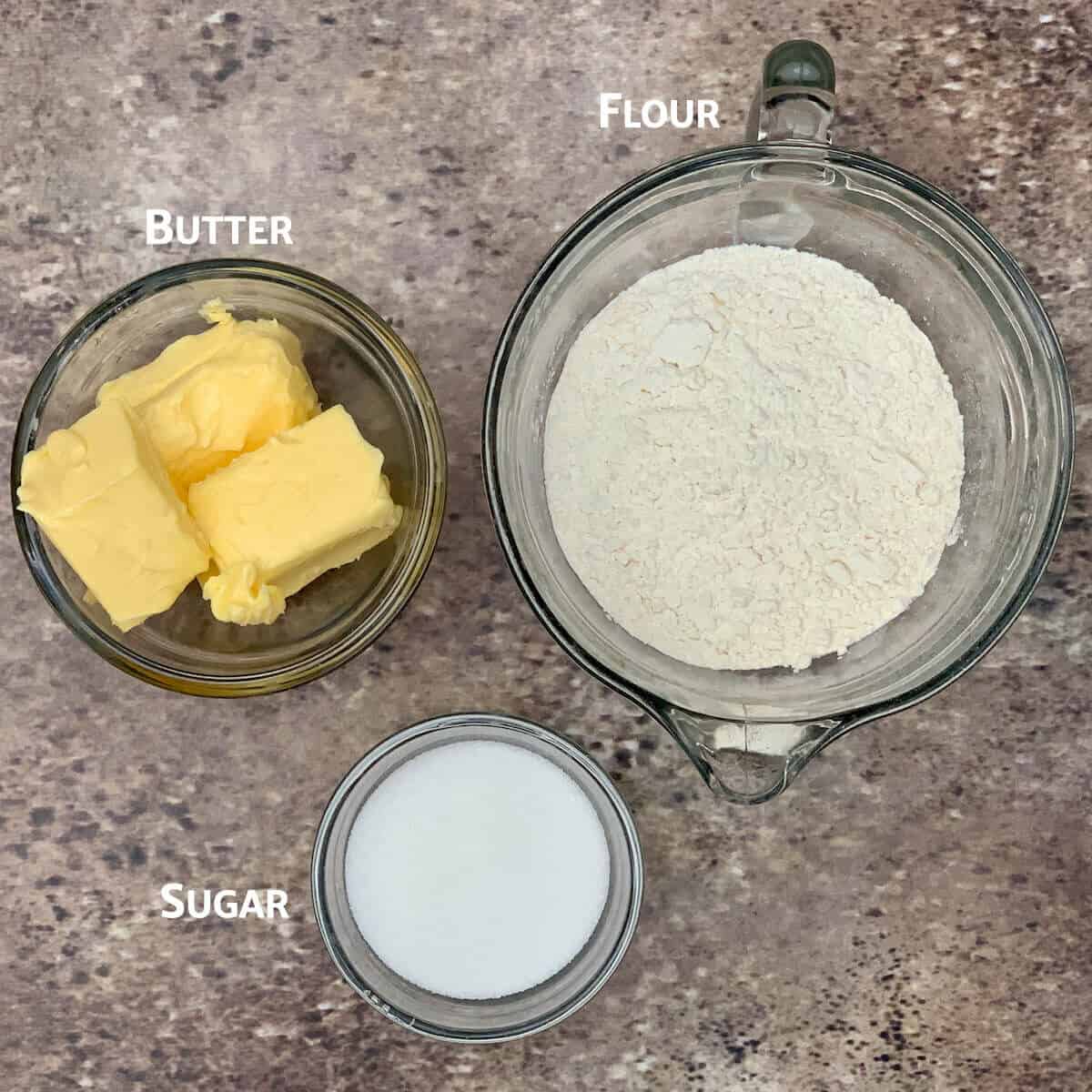 Scottish shortbread ingredients in glass bowls from overhead.