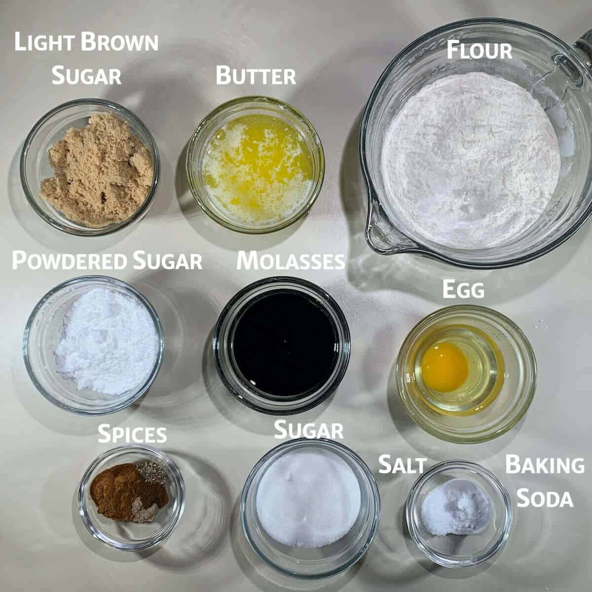 Molasses cookies ingredients in glass bowls.