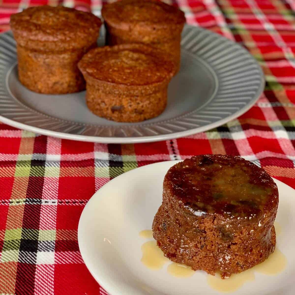 Sticky Toffee Pudding plated on plaid with more in background