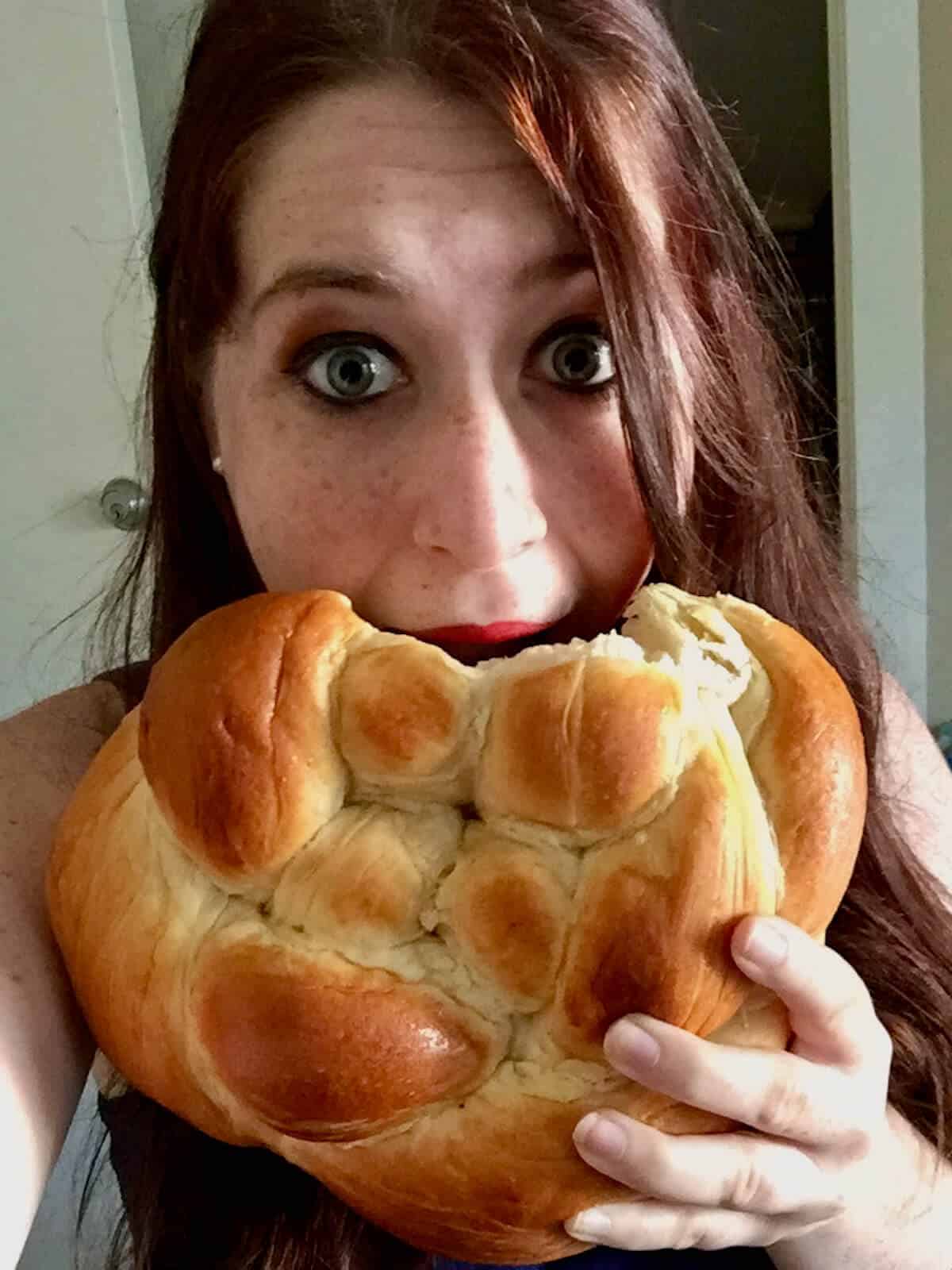 Author's younger daughter eating round braided challah.