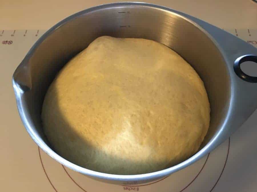Challah dough rising in a bowl