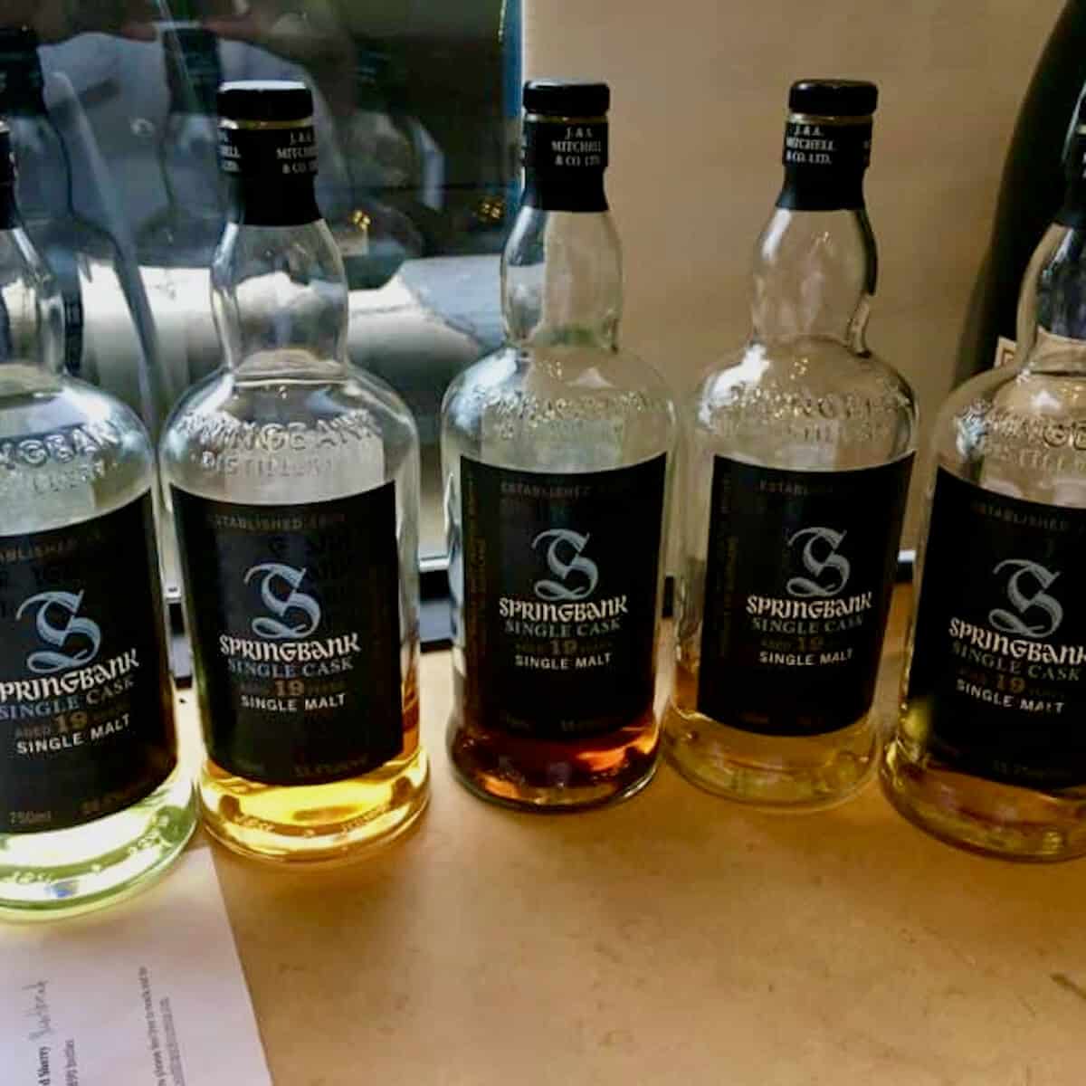 Springbank Single Malt Oak Exploration lineup bottles on a table.