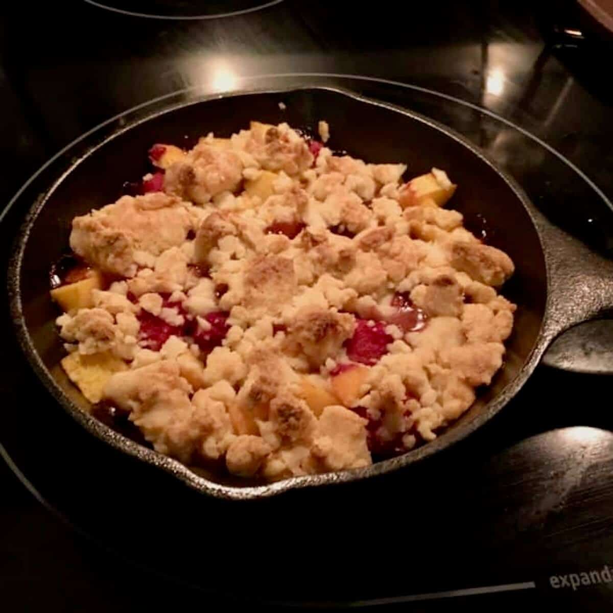 Raspberry Peach Crumble in a mini cast iron skillet.