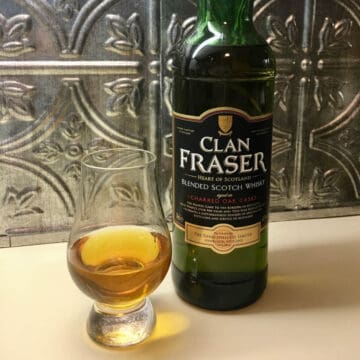 Clan Fraser blended scotch whisky bottle with poured glass.