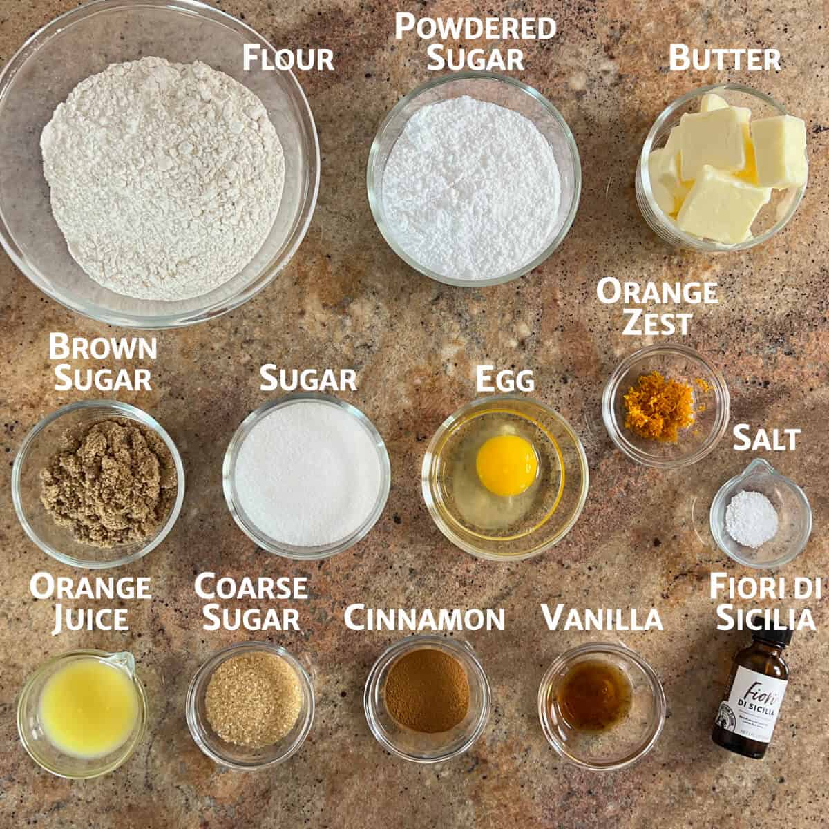 Cinnamon roll cookie ingredients portioned into glass bowls.