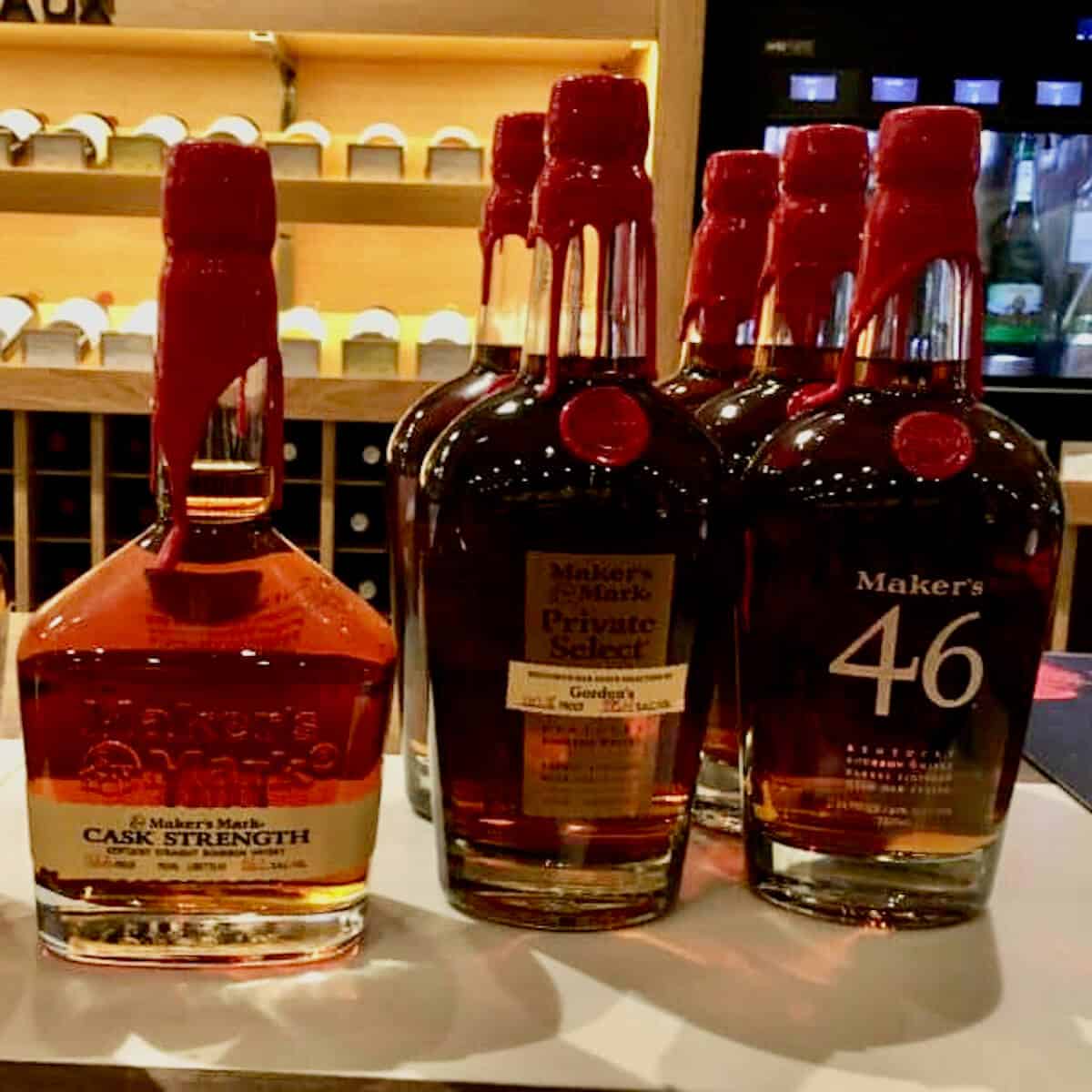 Maker's Mark whisky lineup bottles on a counter.