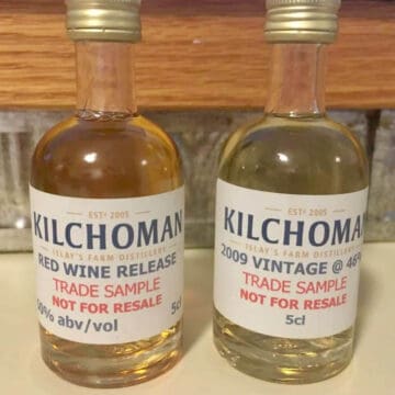 Kilchoman sample bottles with the labels on a counter.