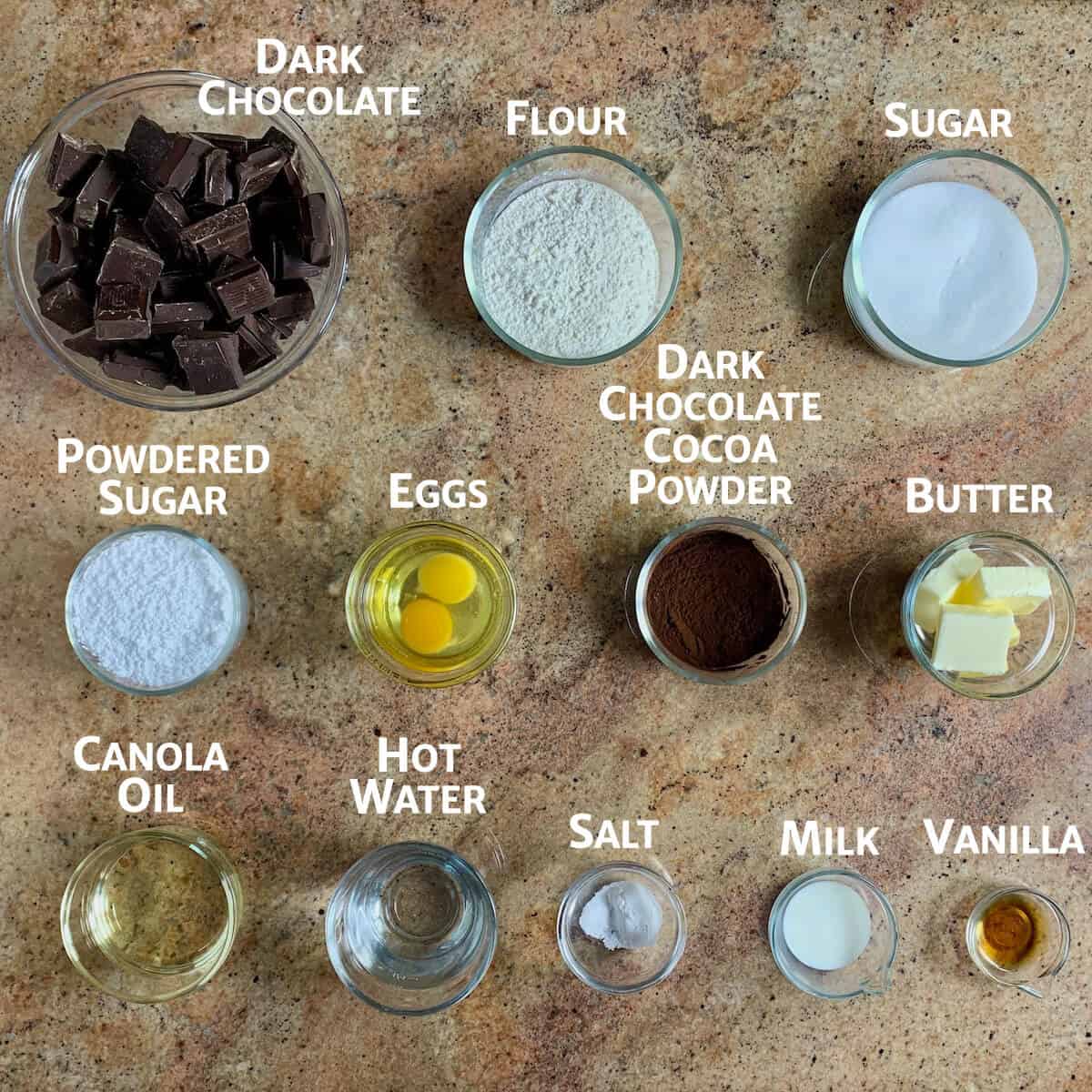 Ingredients for chocolate cake truffles portioned in glass bowls.