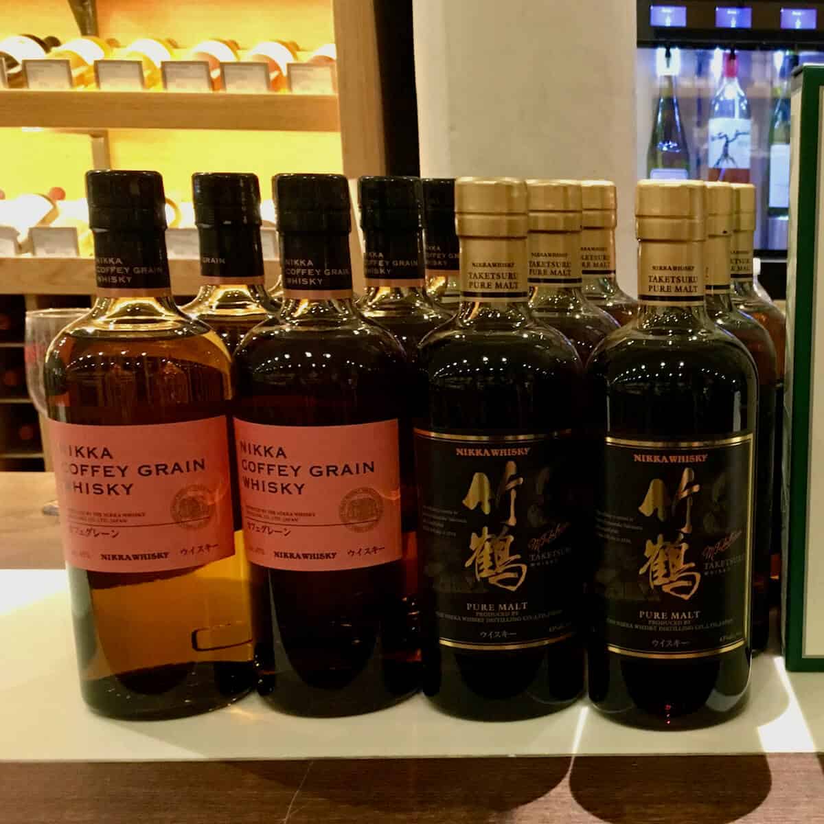 Nikka whisky tasting lineup in bottles on a counter.