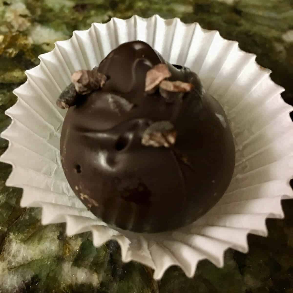 Chocolate Cake Ball in a muffin liner on a counter.