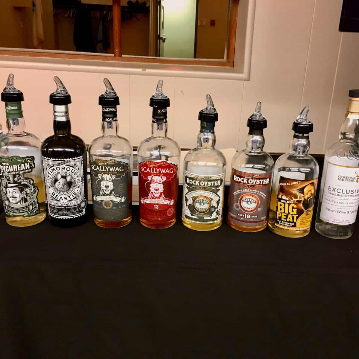 Douglas Laing Remarkable Regional Malt lineup in bottles on a table.