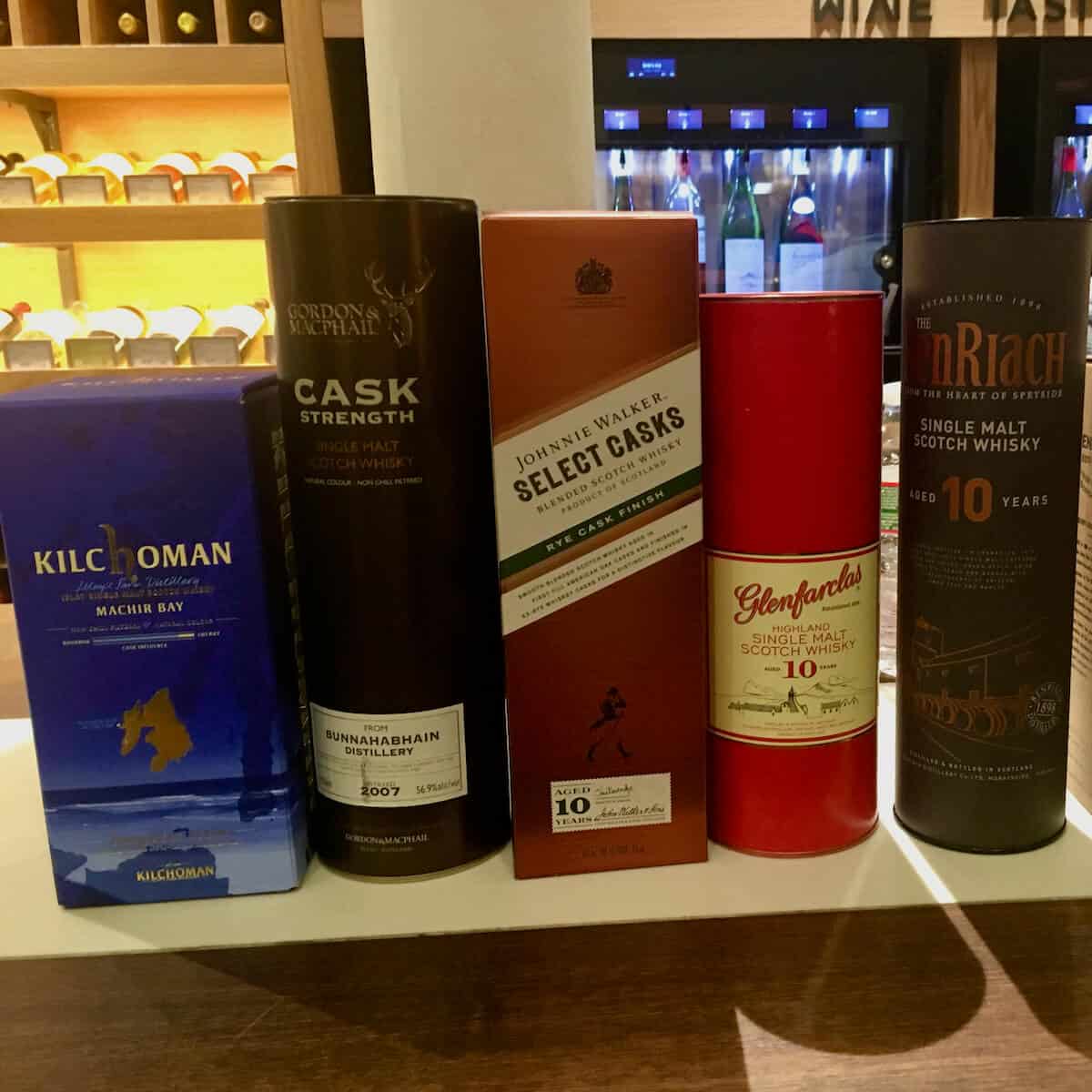 Scotch whisky lineup bottle sleeves under $70 on a counter.