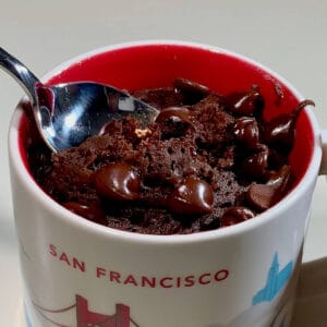 Chocolate mug cake with inserted spoon.