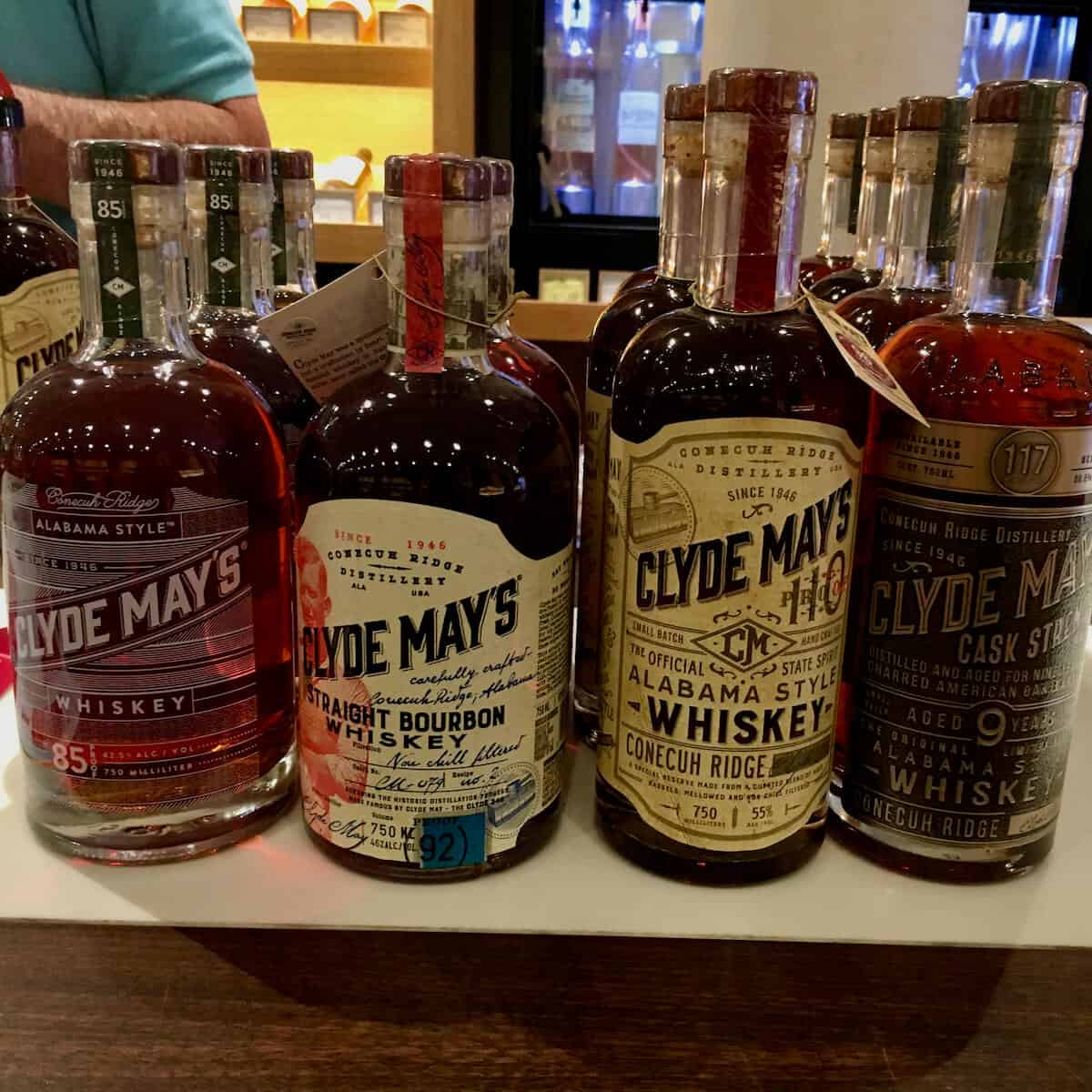 Clyde May's Alabama-style whiskey lineup in bottles on a counter.