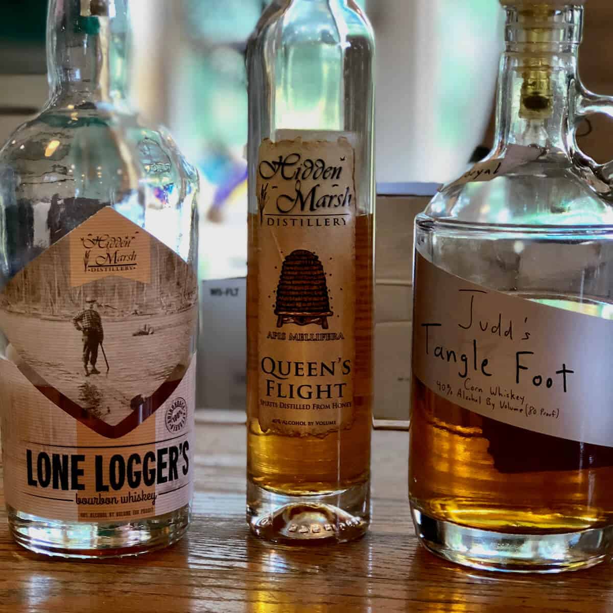 Hidden Marsh Distillery tasting lineup bottles on a counter.