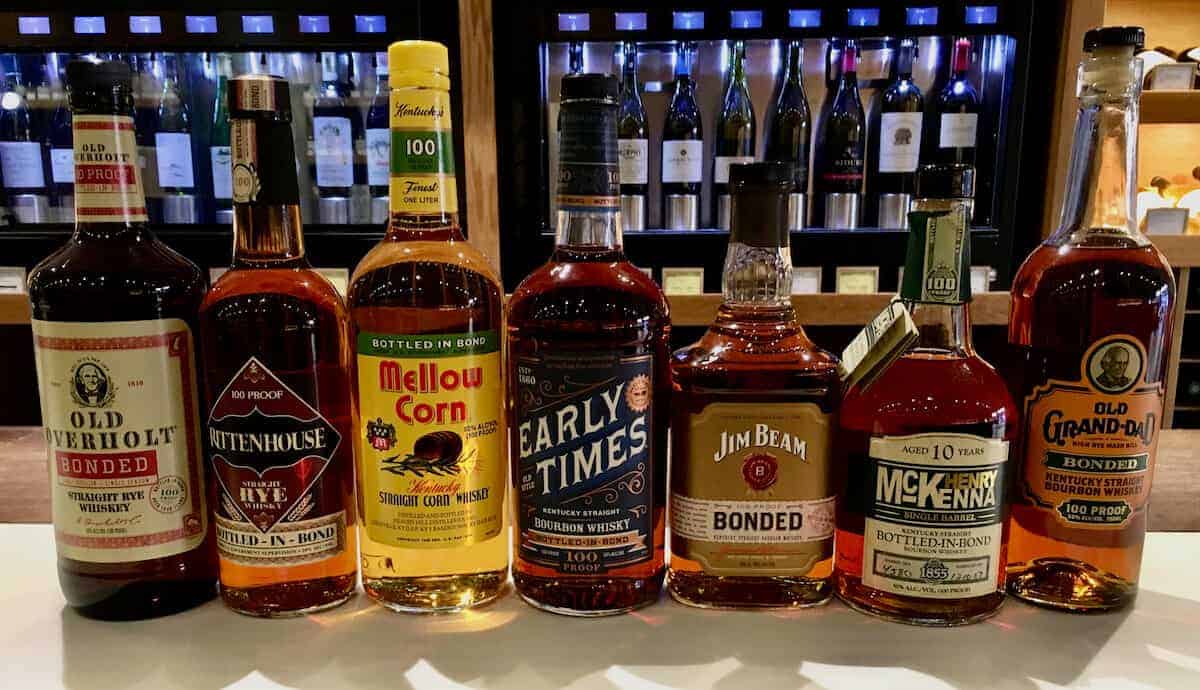 Bottled in bond bourbon lineup in bottles on a counter.