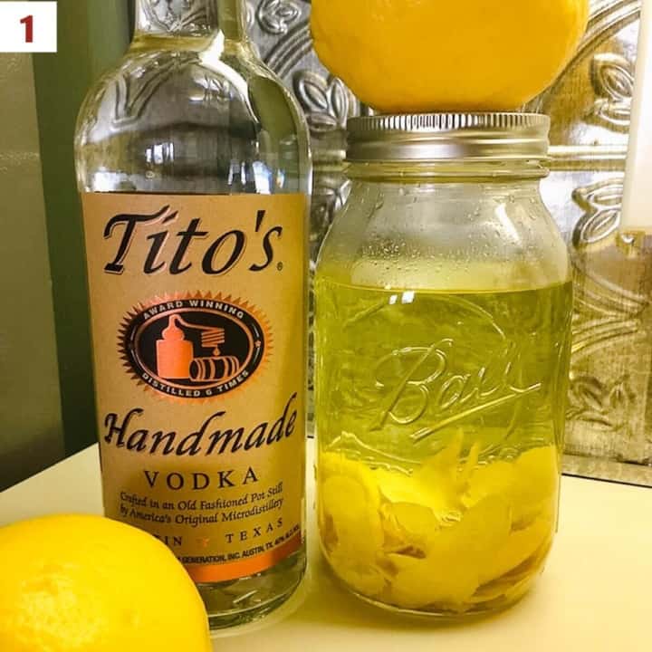 Two lemons with vodka in the bottle and vodka & lemon peels in a mason jar.