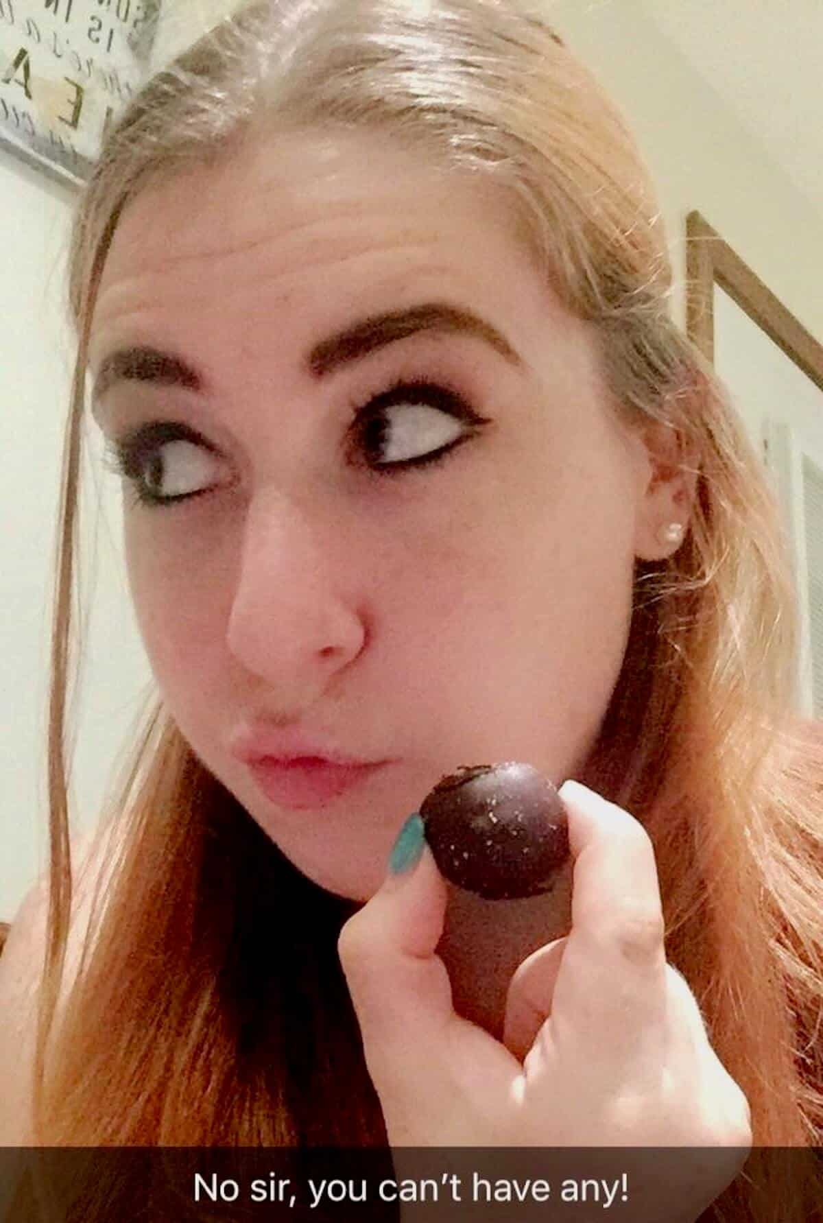 Author's daughter holding a tiramisu truffle.