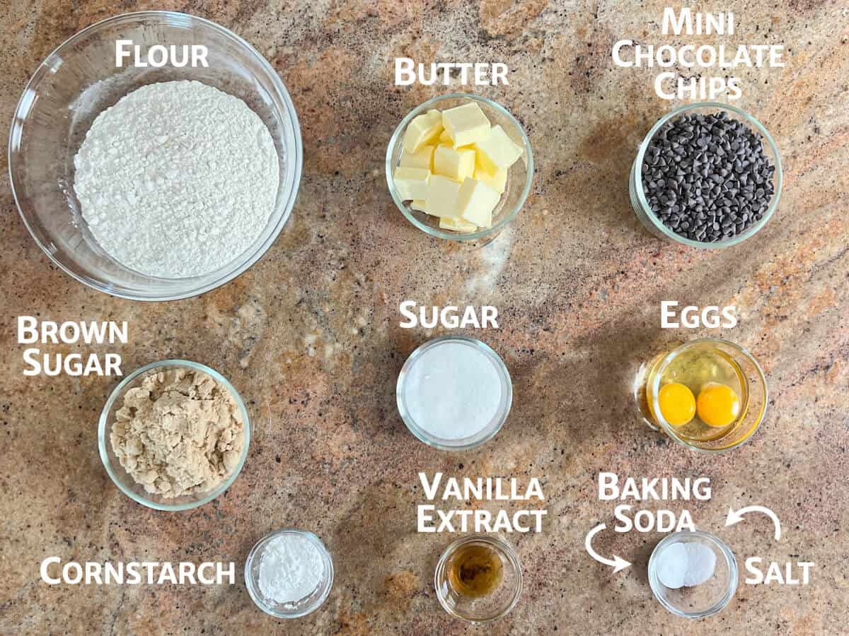 chocolate chip cookie cake ingredients portioned into glass bowls from overhead.