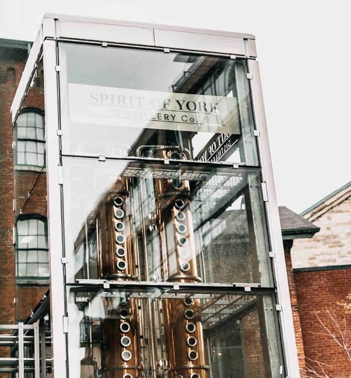 Spirit of York distillery's glassed-enclosed column still.