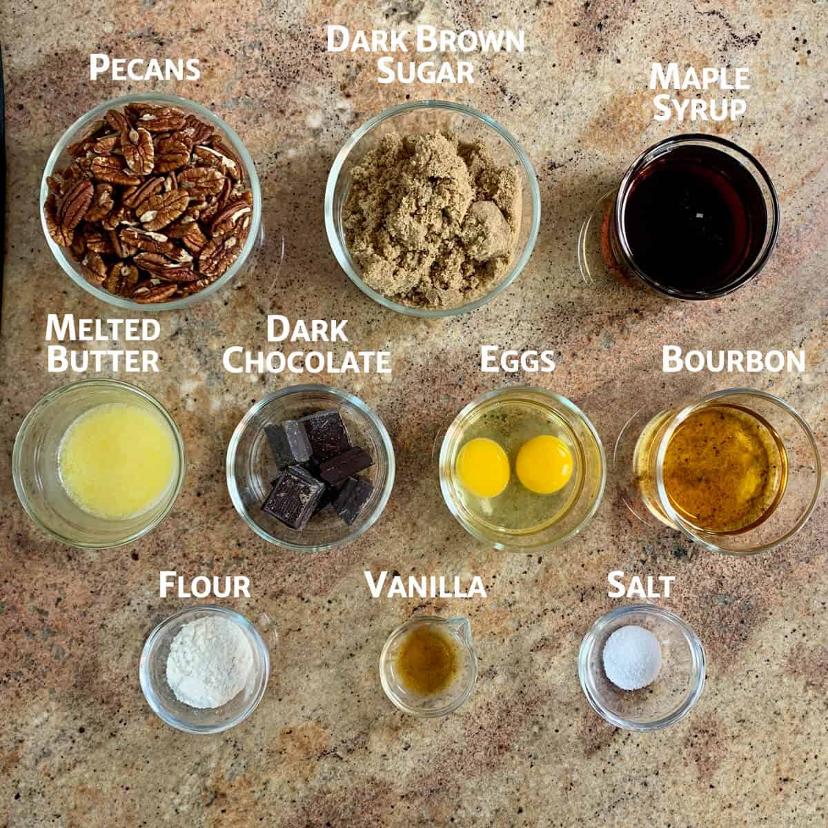 Ingredients for maple bourbon pecan pie portioned in glass bowls from overhead.