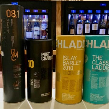 Bruichladdich, Port Charlotte, & Octomore bottle sleeves on a counter.