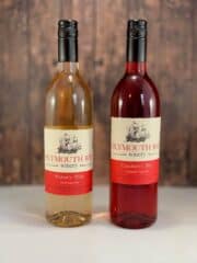 Plymouth Bay Winery Widow's Walk table wine and Cranberry Bay table wine in bottles on a table.