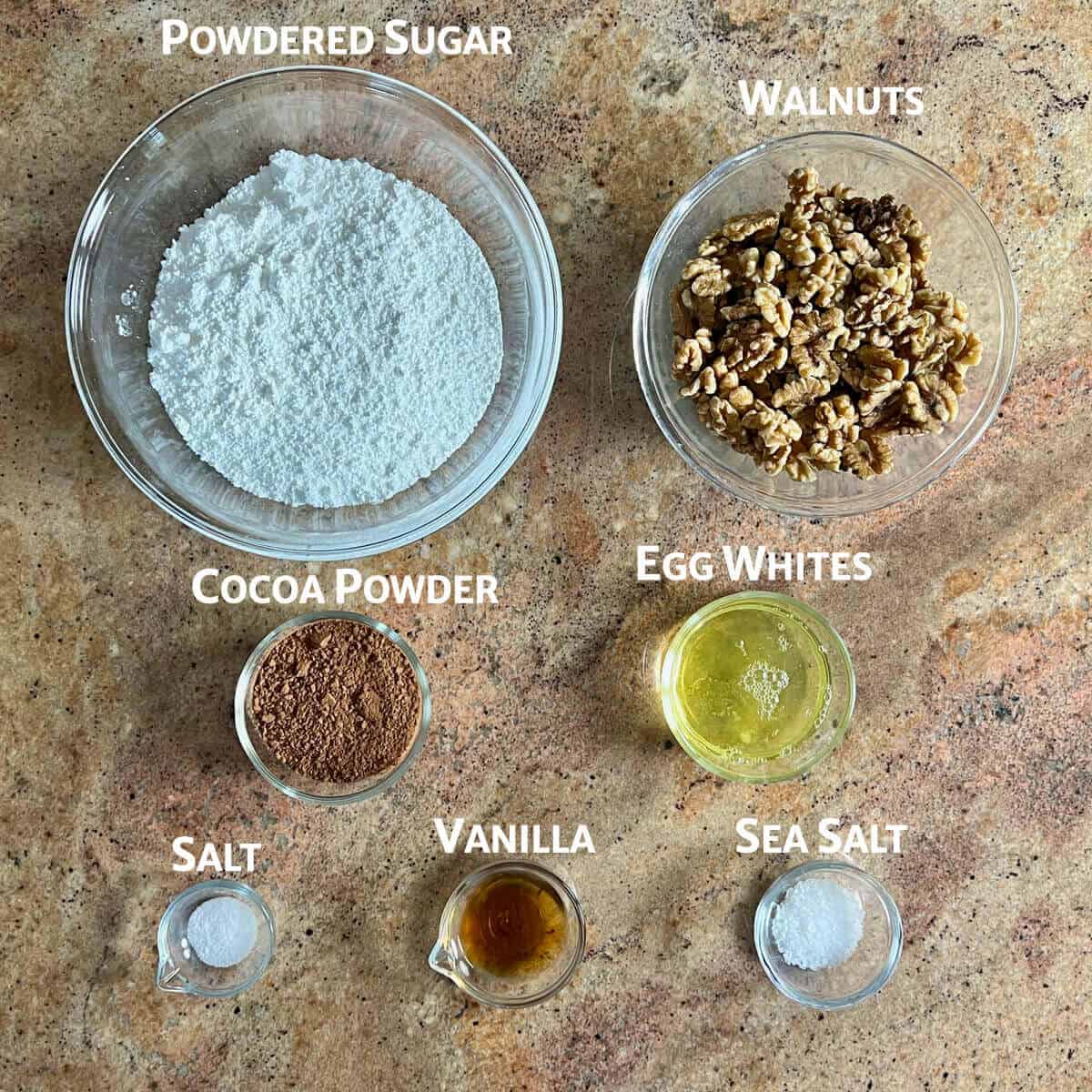 Flourless Chocolate Walnut Cookies ingredients portioned into glass bowls from overhead.