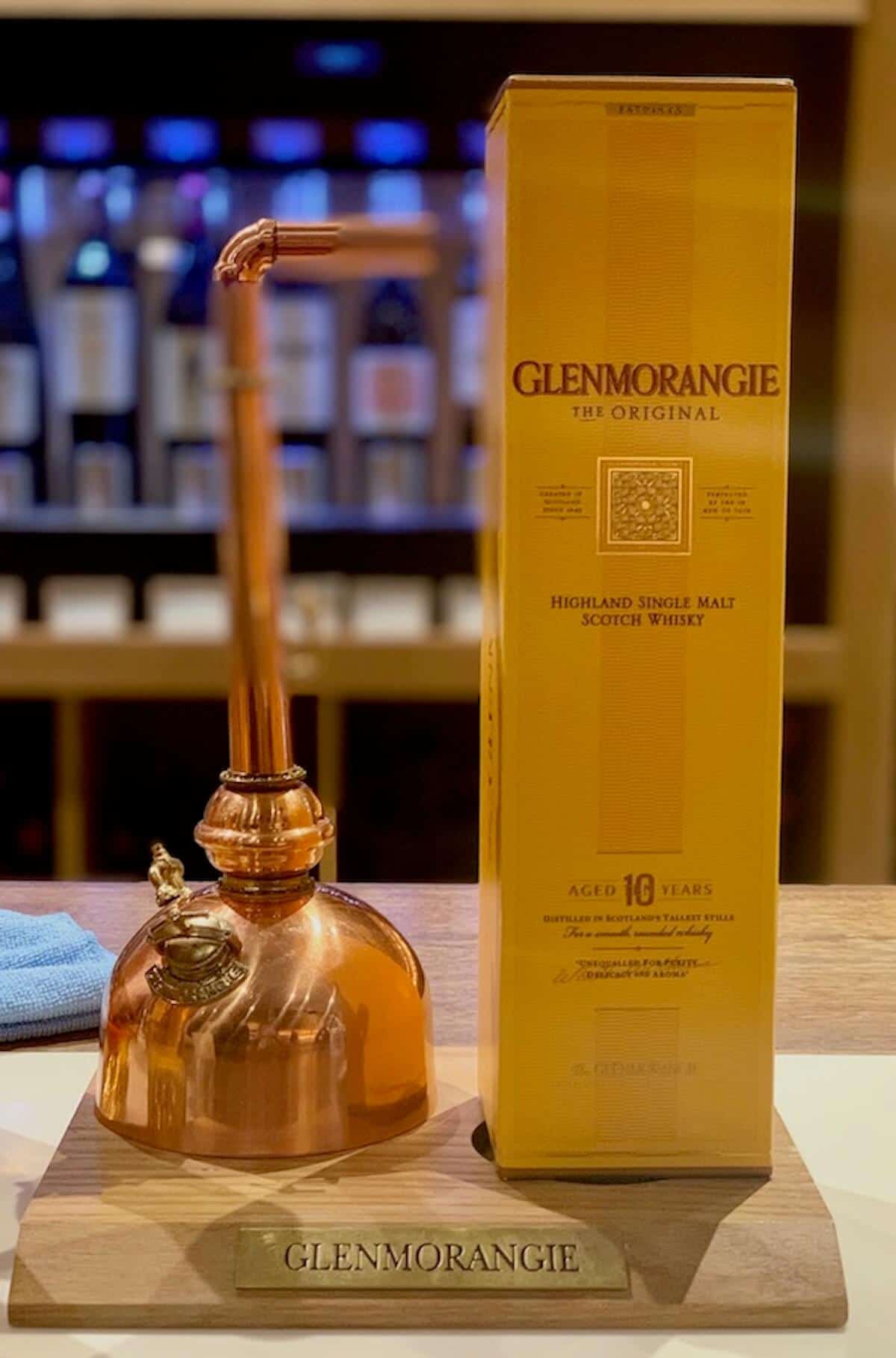 boxed Glenmorangie Allta  with pot still model on a counter.