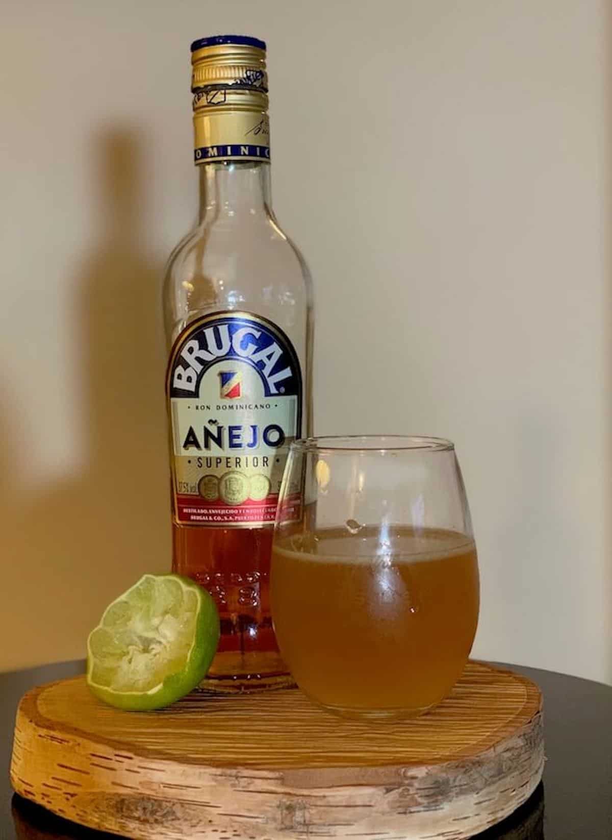 Grog in a glass with Brugal Rum and lime on a table.