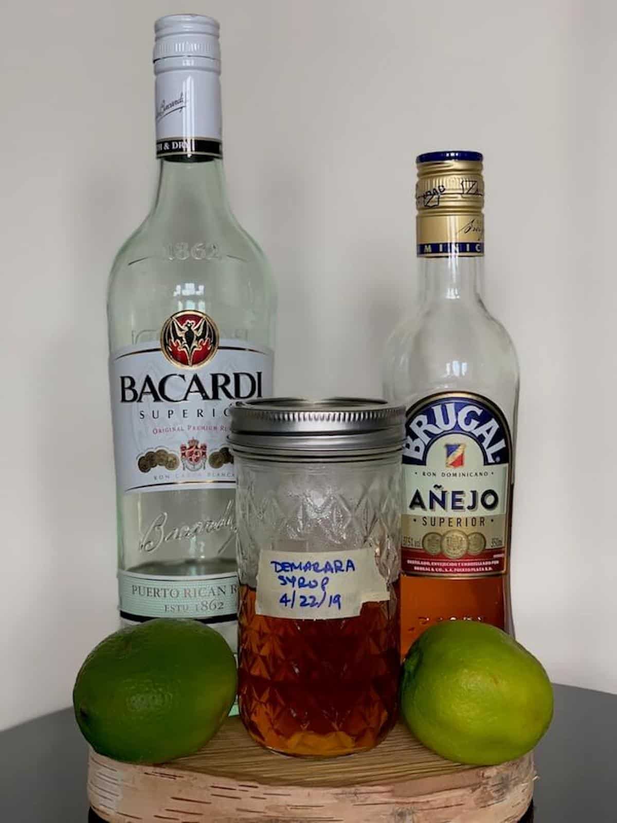 simple rum cocktails ingredients with lime on a table.