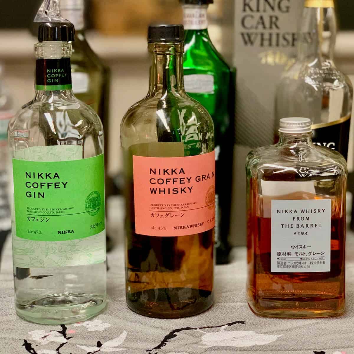Nikka Coffey Gin, Coffey Grain, Nikka Whisky from the barrel in bottles on a table.