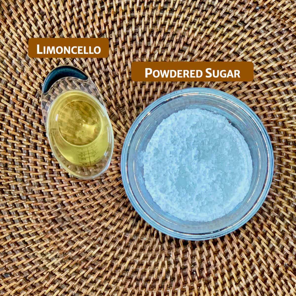 Limoncello glaze ingredients portioned into glass bowls on a woven tray from overhead.