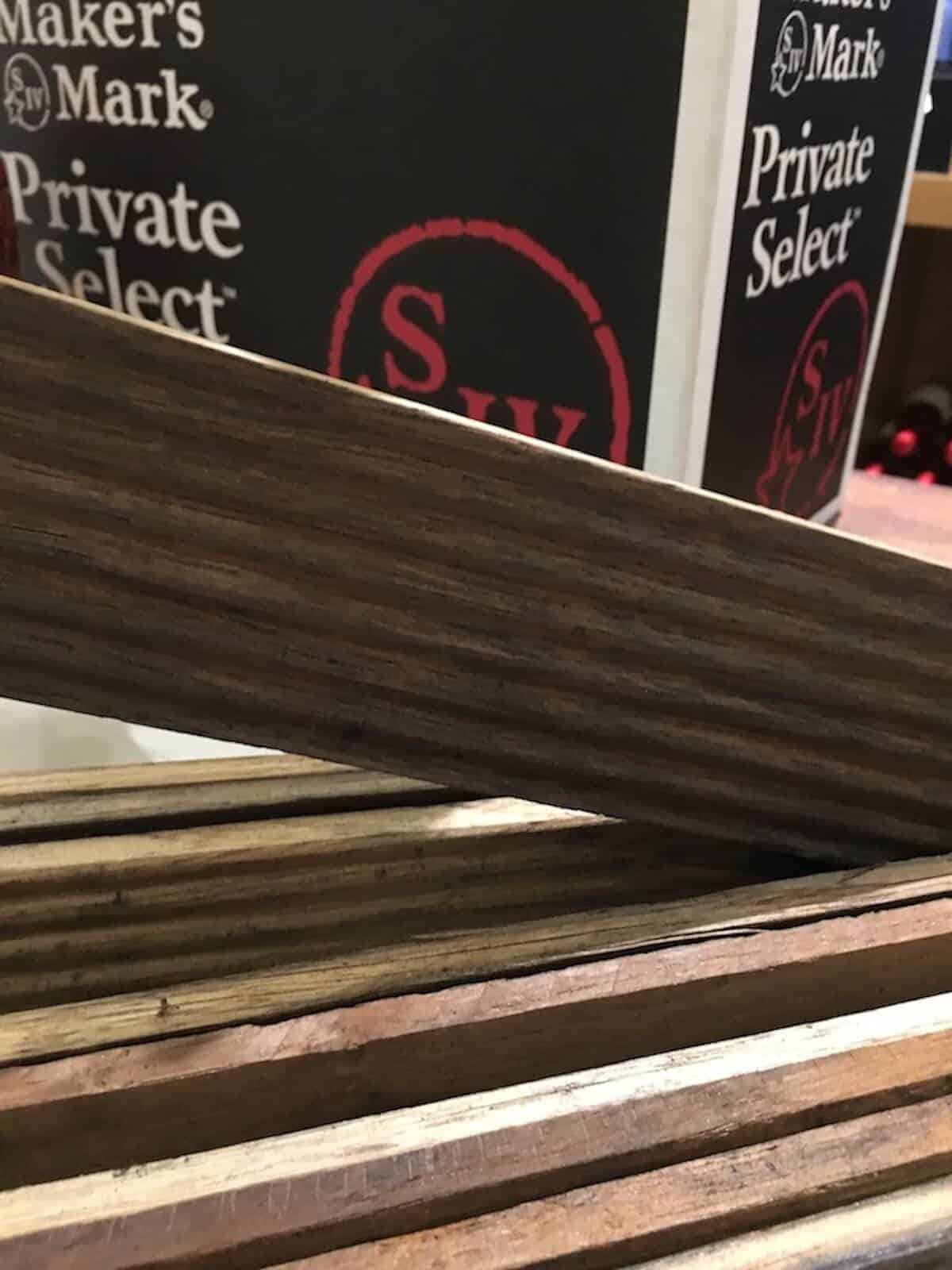 Maker's Mark finishing staves on a counter in front of a box.