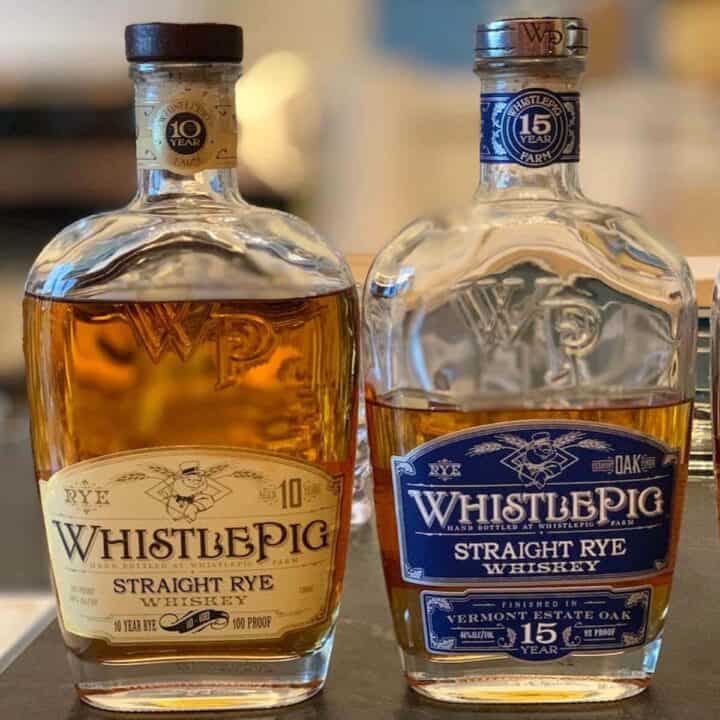 WhistlePig Rye Straight 10yr, WhistlePig Rye Straight 15yr on a counter.