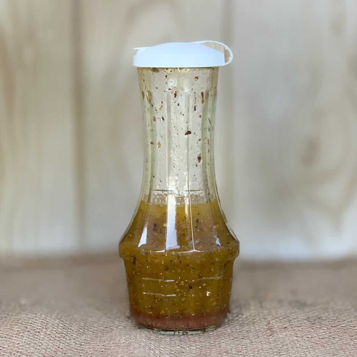 White Wine Herb Vinaigrette in a cruet dressing bottle.