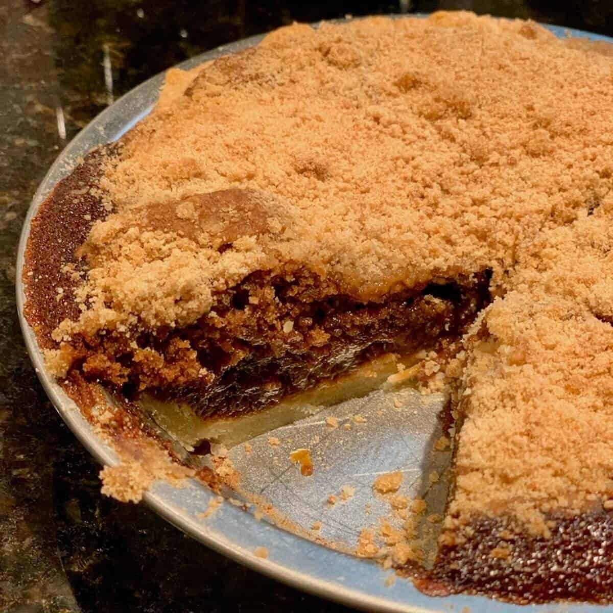 Cut mini Shoofly Pie on a black marble counter.