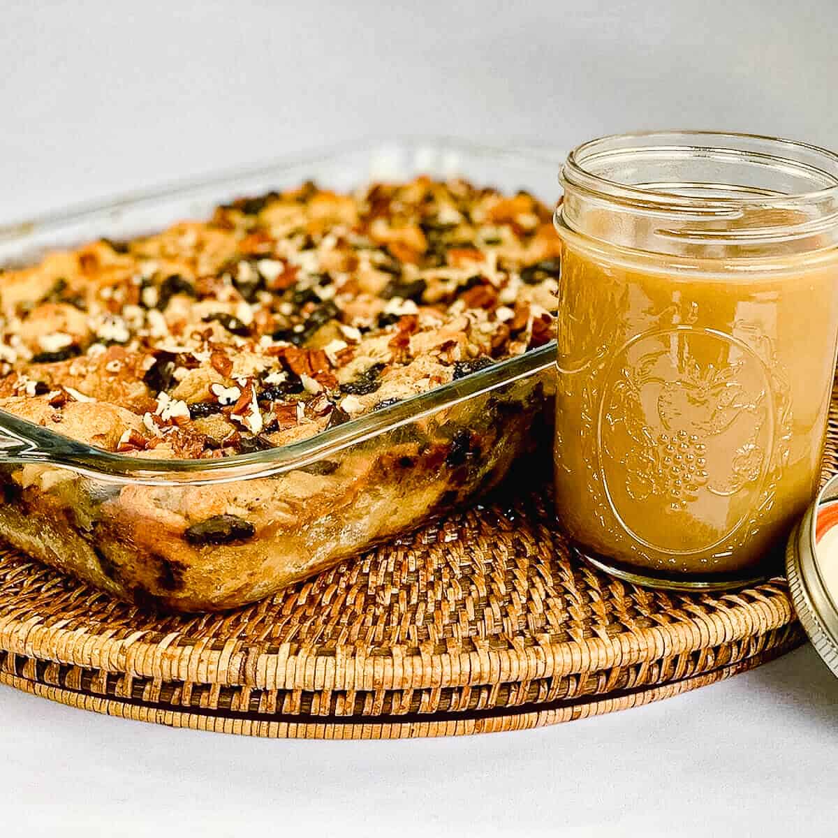 Chocolate Chip Bread Pudding with sauce on a wooden tray.