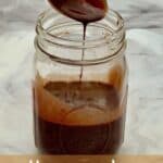 Chocolate syrup dripping from spoon into a jar Pinterest banner.