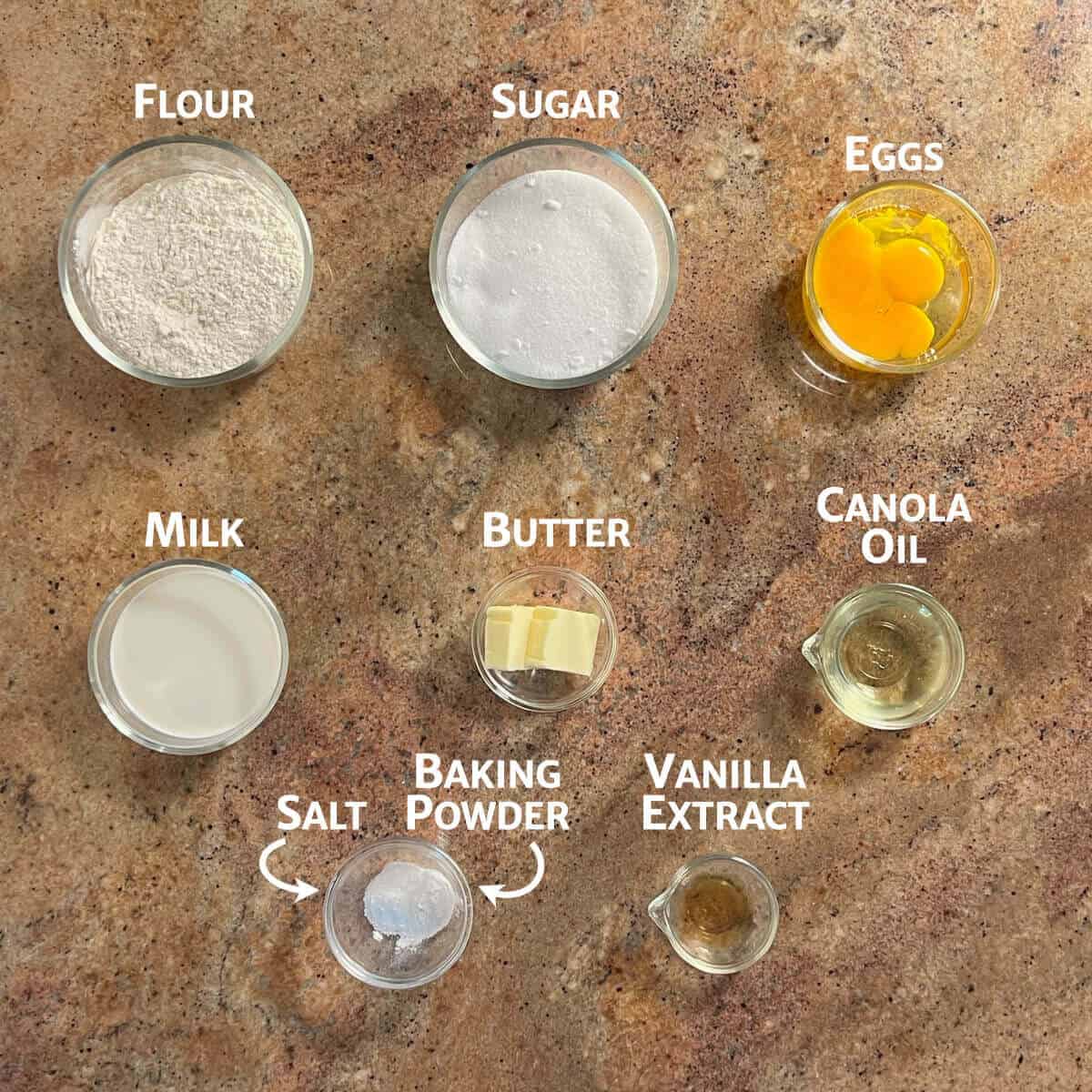 Ingredients for hot milk cake portioned into glass bowls from overhead.