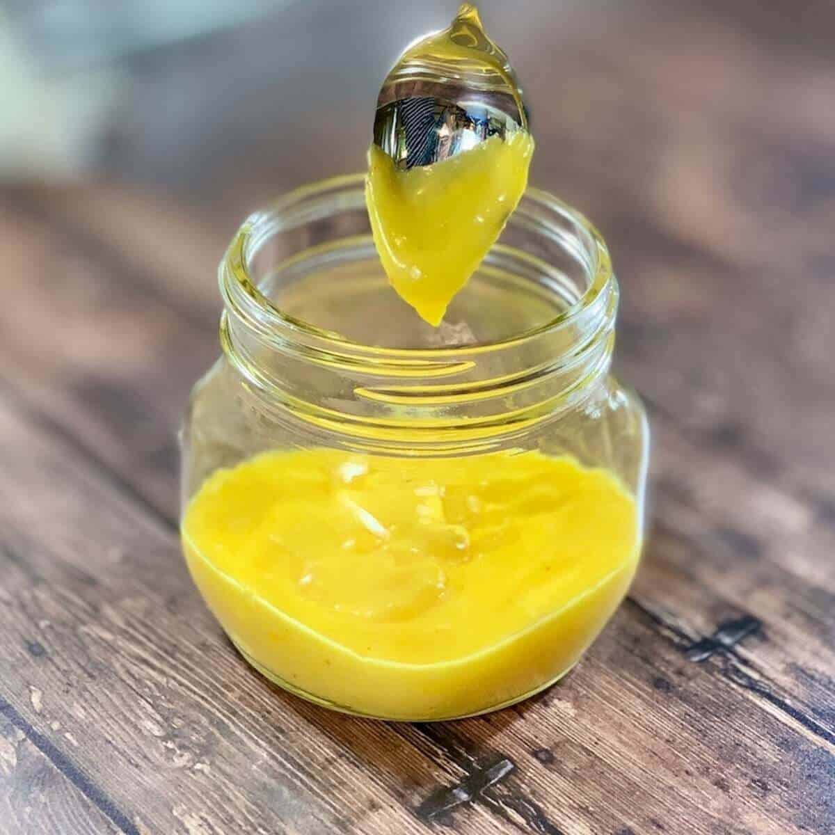 Hollandaise sauce dripping into a jar.