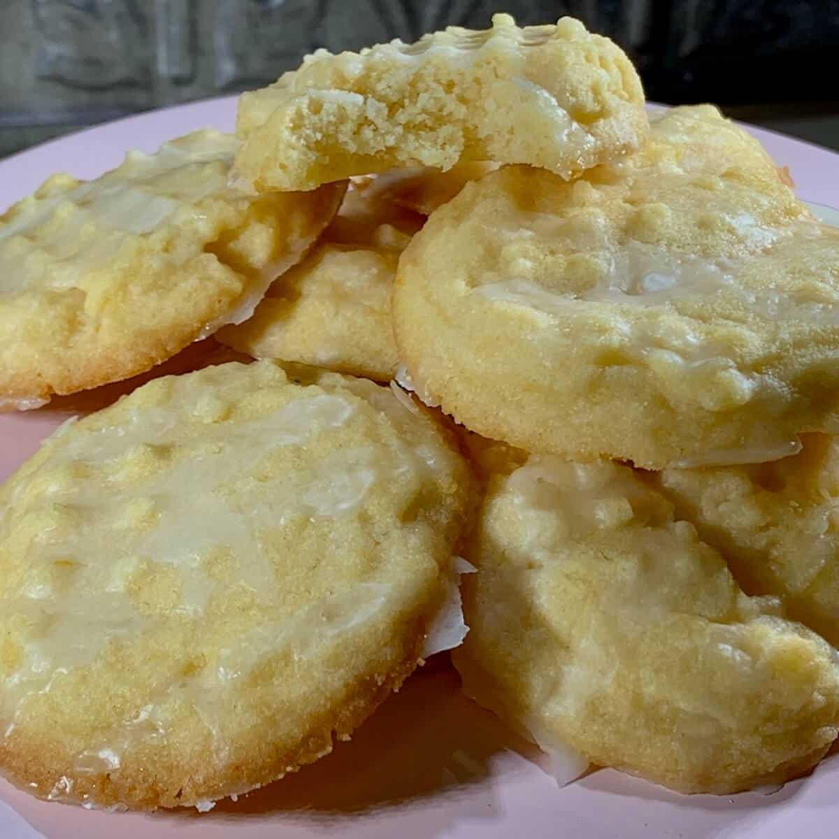 Lemon shortbread stacked on a pink cake stand.