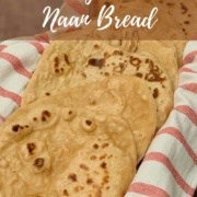 Eight sourdough naan pieces on a red & white striped towel in a basket Pinterest banner.