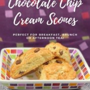 Chocolate chip cream scones stacked on a white plate with colorful checks Pinterest banner.